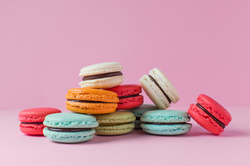 Beautiful colourful desserts. french macaroons on a pink background