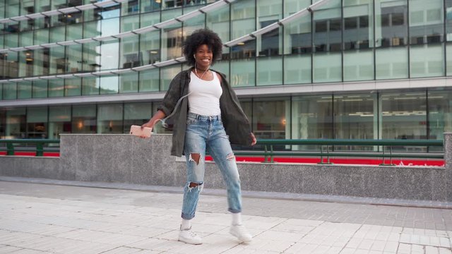 happy young attractive girl spinning smiling listening to music on the phone