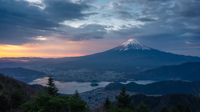 Time lapse of Fujisan volcano mountain, iconic peak of Japan in a morning sunrise in cloudy day, Japan