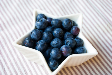 Fresh organic blueberry in star shape bowl. Health food.