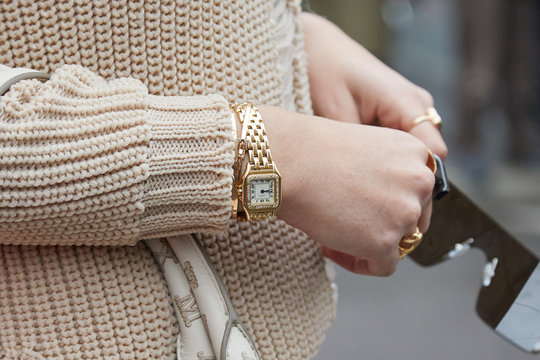 Woman With Golden Cartier Watch With Diamonds And Brown Sweater On February 22, 2018 In Milan, Italy