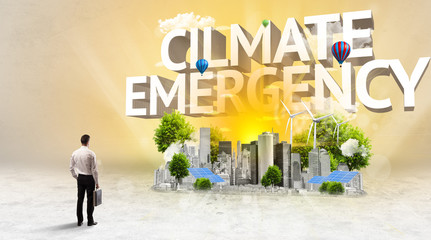 Rear view of a businessman standing in front of CILMATE EMERGENCY inscription, Environmental protection concept