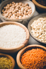 Organic products. Bowls with different gluten free grains on white background