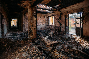 Fototapeta na wymiar Burnt and collapsed old house interior. Consequences of fire