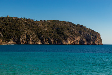 Fototapeta premium Rocks beautiful beach turquoise sea water, Camp de Mar, Majorca island, Spain