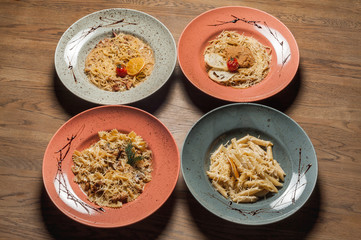 four different
Italian pasta stand on a wooden table