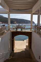 beautiful laid table in a restaurant overlooking the mediterranean sea in sant elm, mallorca, spain