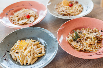 four different
Italian pasta stand on a wooden table