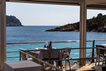 beautiful laid table in a restaurant overlooking the mediterranean sea in sant elm, mallorca, spain