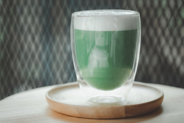 Iced green tea with milk foam.