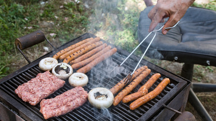 Grilling meat in smoke