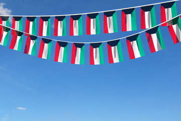 Kuwait flag festive bunting hanging against a blue sky. 3D Render