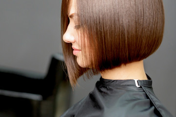 Woman with short hairstyle in hair salon with copy space.