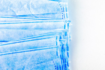 stack of medical hygiene masks on the white background close-up