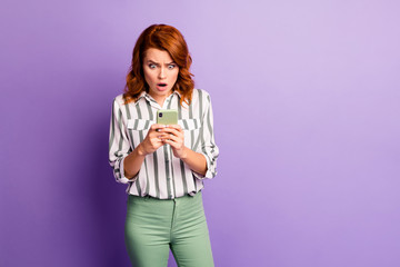 Unbelievable news. Astosnihed crazy addicted blogger woman use smart phone get social network notification scream wow omg wear formalwear style clothing isolated purple color background