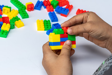 Thailand, bangkok. April 29, 2020. Children hands play with colorful blocks on white background.