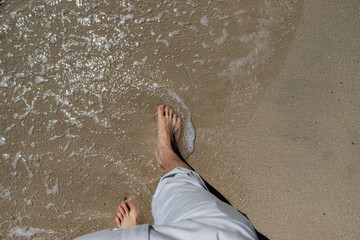 top down view of male feet waiting for a wave to come in, oh the anticipation copy space too.