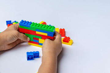 Thailand, bangkok. April 29, 2020. Children hands play with colorful blocks on white background.