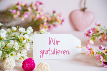 Label With German Text Wir Gratulieren Means Congratulations. Rose And White Flowers With Heart...