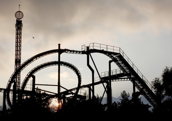 Abandoned roller coaster ride at dawn.    