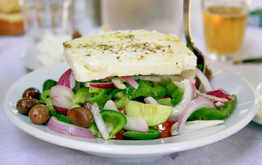 Fresh Greek salad in the restaurant on a plate