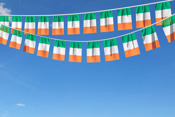 Ireland flag festive bunting hanging against a blue sky. 3D Render
