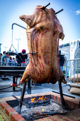 Russia, Yekaterinburg. Gastronomic barbecue festival .08.06.2019. Roast suckling pig fried on a...