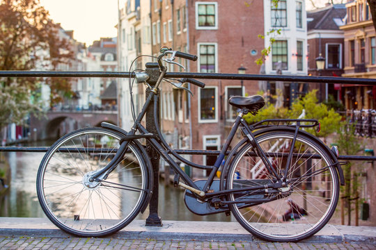 Bicycle in the center of Utrecht in the Netherlands with canals in the background