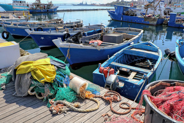 Fototapeta na wymiar Fishing boat moored in the port of the historic center of Taranto, Puglia, Italy 