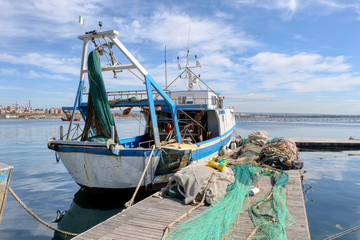 Fishing boat moored in the port of the historic center of Taranto, Puglia, Italy 