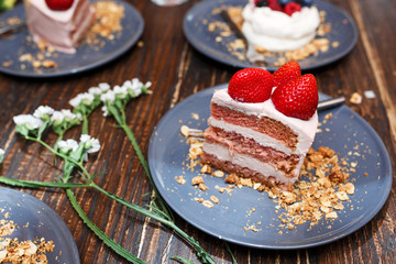 Sweet cakes with summer berries on a wooden table. Party, sweet table. Summer offer desserts in the restaurant.