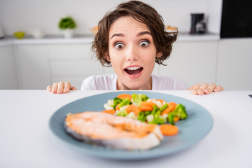 Close up photo of funny housewife lady cunning tricky hungry eyes look from under table ready to...