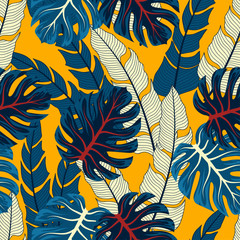 Abstract seamless tropical pattern with bright plants and leaves on a yellow background. Summer colorful hawaiian seamless pattern with tropical plants. 
Beautiful print with hand drawn exotic plants.