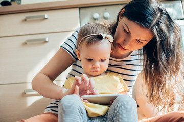 Calm woman switching on the cartoon for her daughter stock photo