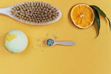 On an orange background are care products: a body wash, a bomb and sea salt for the bath. For...