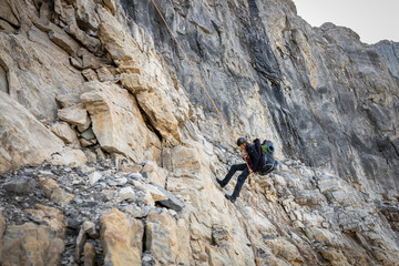 Man Rappelling from Cliff