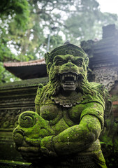 ancient statue in monkey forest bali indonesia