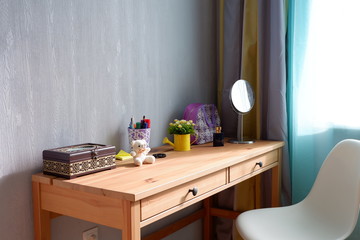 Wooden table with items by the window