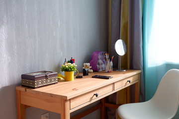 Wooden table with items by the window