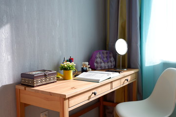 Wooden table with items by the window