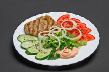 White ceramic plate with food on grey background