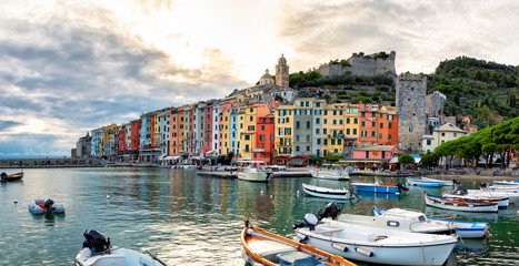  Panorama of the middle-aged town of Portovenere. Colorful houses in Italian style. Harbor with fishing boats and yachts. Sea coast in Cinque Terre. © Andrii Marushchynets