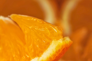 A piece of orange fruit macro view. Orange fruit background