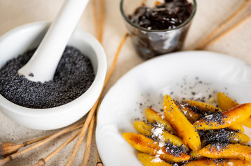 Sweet potato dumpling (wedges) with poppy seeds, plum jam and mortar.
