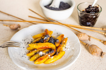Sweet potato dumplings (wedges) with poppy seed, poppy heads, plum jam.