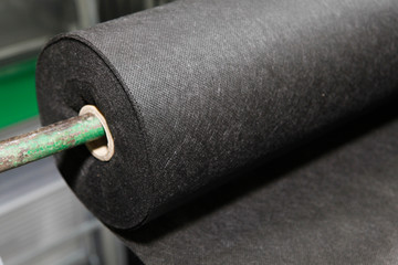 A close-up on black biodegradable polypropylene saturated bonded spunbond, spunlaid non woven...
