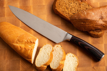 A loaf of bread sliced into slices with a knife