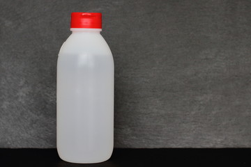 bottle of soap, shampoo, shower gel, antiseptic,disinfectant or other sanitizer on black stone texture background, copy space