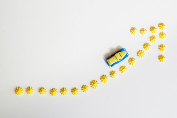 Children's yellow blue car toy. Rising up arrow. Coin staircase. Concept of Savings money, Money growth, Profit business and Investment for the future