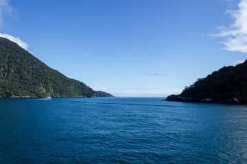 Fototapeta premium Milford Sound on a ferry on a beautiful blue sky day, Fiordland, South Island,New Zealand.